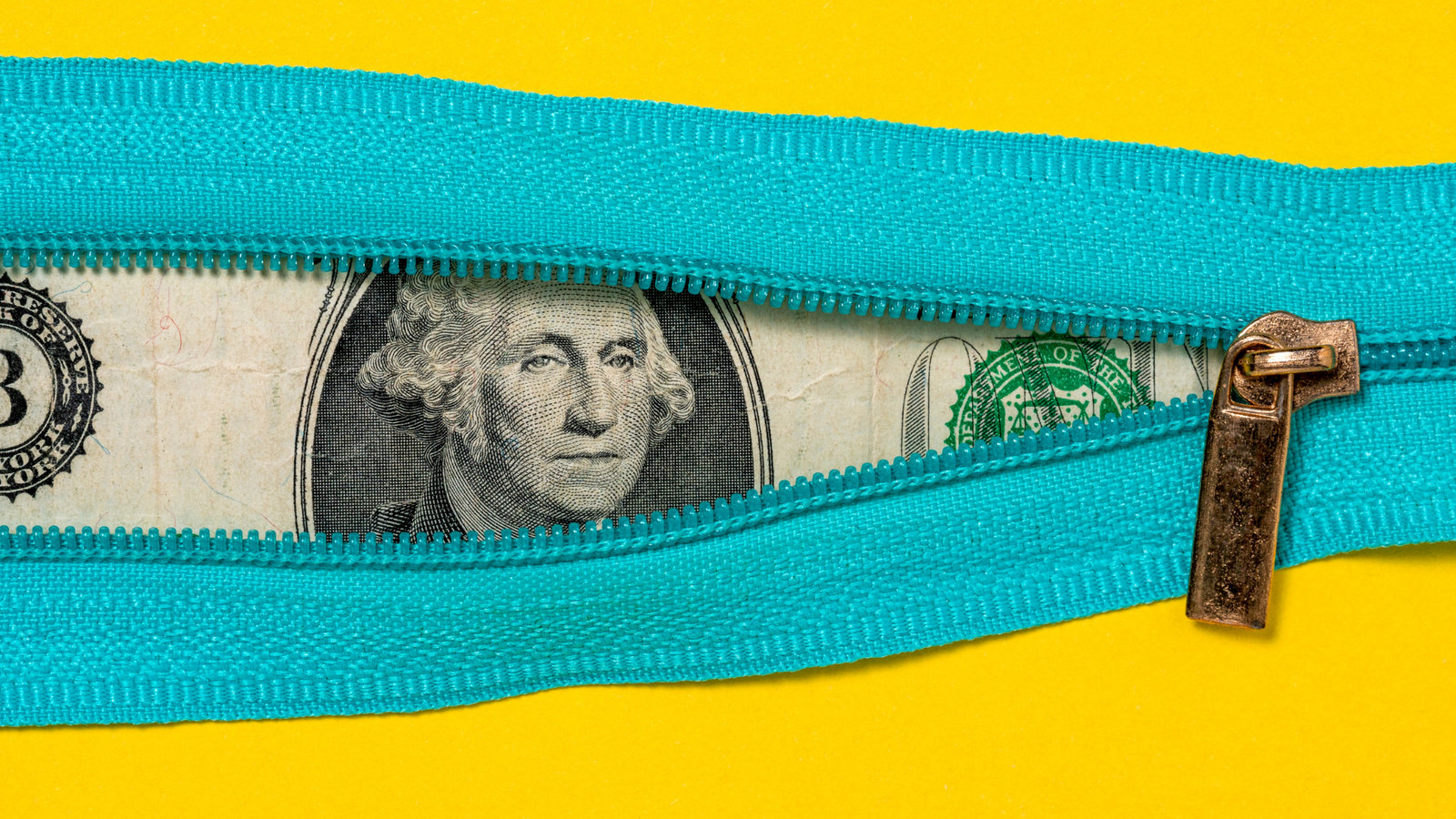 US Dollar bill peeking out through open zipper